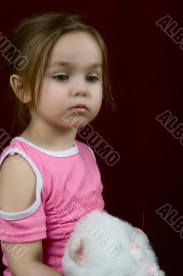 The small offended girl with a toy