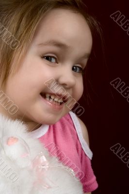 The small artful girl with a toy