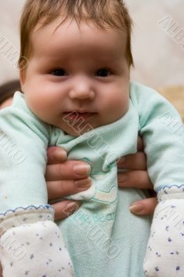 Portrait of the small baby at mum on hands