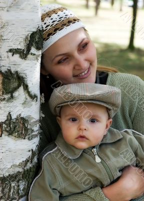 Mum and the child in a birch wood
