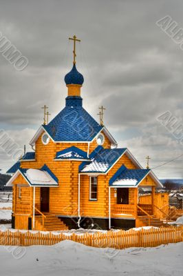 Russian wooden church with a dome and crosses