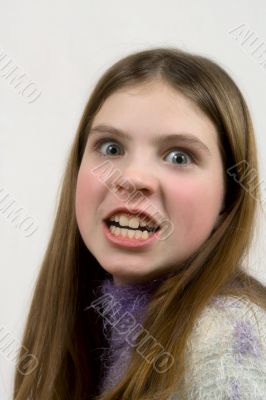 Portrait of the furious girl on a gray background