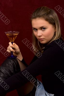 The fine girl with a glass in hands