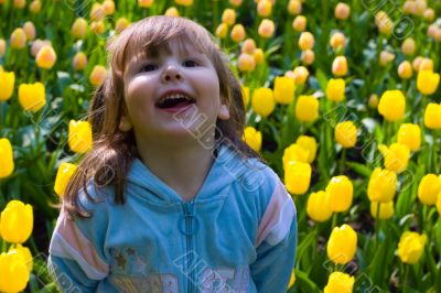 Laughting girl in tulips