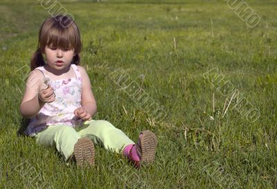 Little girl and dandelion