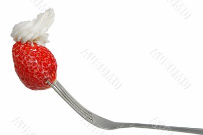 Strawberry with whip in a fork
