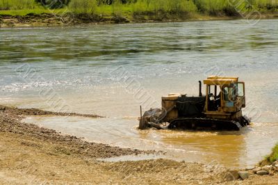 Tractor working in water