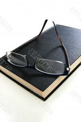 eyeglasses on book