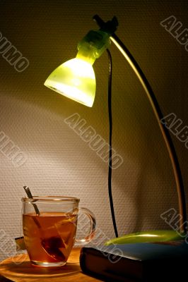bedside table with tea and book