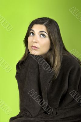 Thinking woman rolled in a blancket
