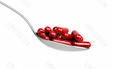 Spoon with red capsules