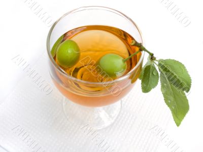 Branch with plum in a wine-glass