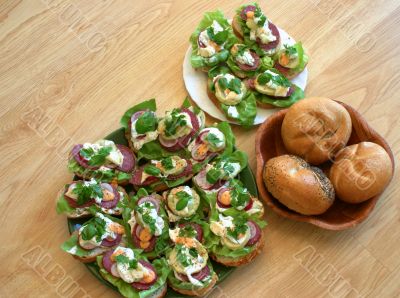 Two plates of sandwiches put on table in kitchen