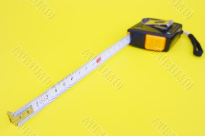 tape measure isolated on yellow