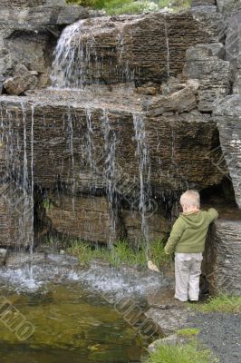 boy watching waterfall