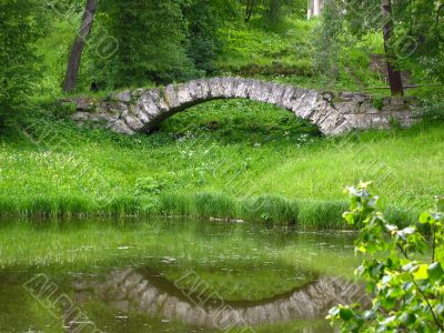 Reflection of stone bridge in lake