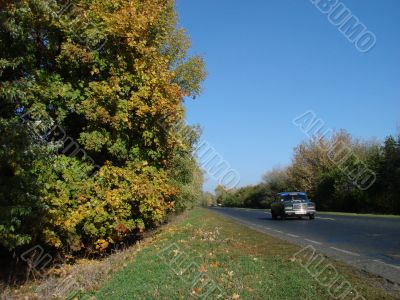 Autumn road with deep blue sky