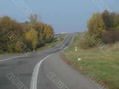 Autumn road with deep blue sky