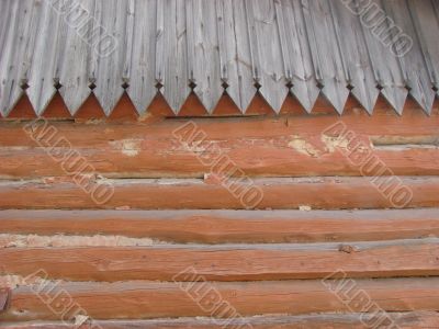 Old log wall and wooden roof