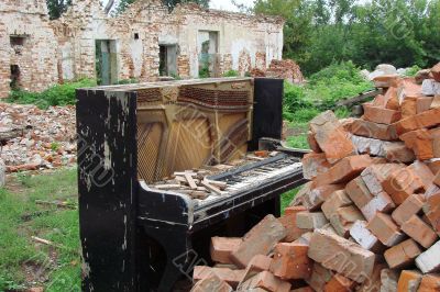The Old Broken Piano Among Ruins