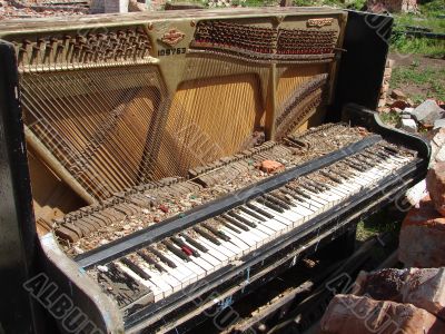 The Old Broken Piano Among Ruins