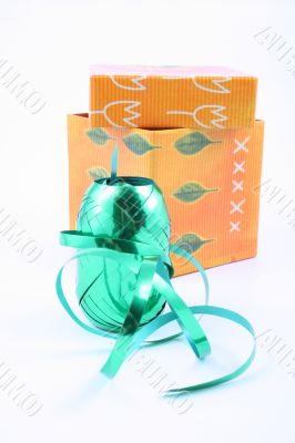green ribbon and colorful box