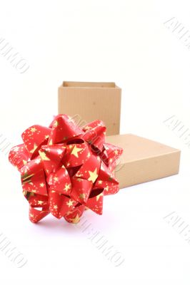 golden box with big red ribbon