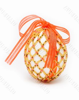 egg with red ribbon