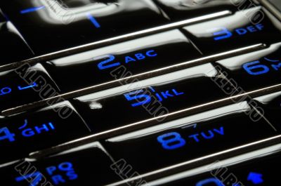 Blue mobile keypad under dark