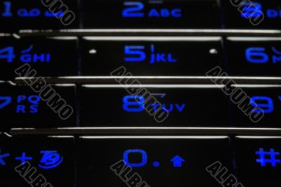 Blue mobile keypad under dark