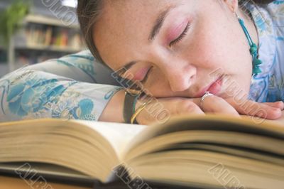 Beautiful student sleeping on the library