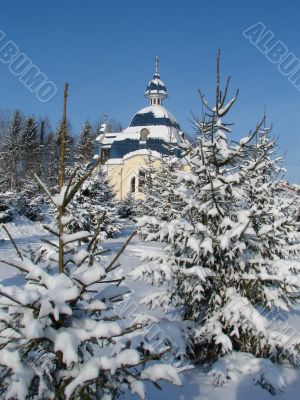 Winter snowy landscape with fur-trees and church