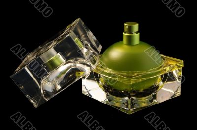 Opened perfume bottle over black