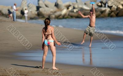 Couple playing frisbee