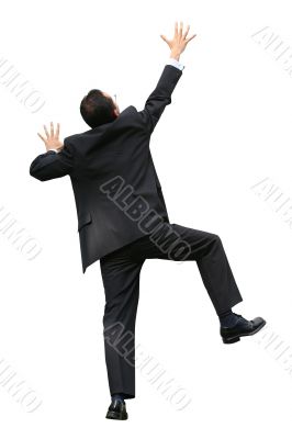 business man climbing a wall