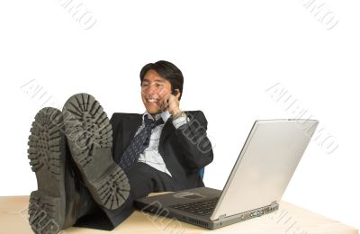 business man with feet up on the phone