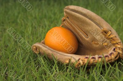 An Orange in a Baseball Glove