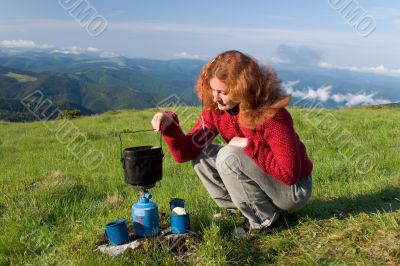 Hiker girl making a coffee