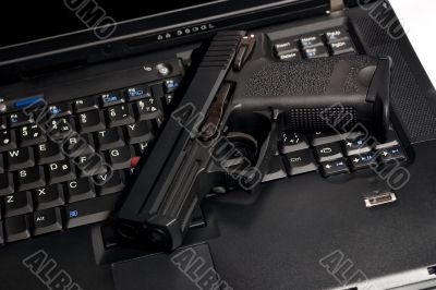 Shot? Black weapon and laptop