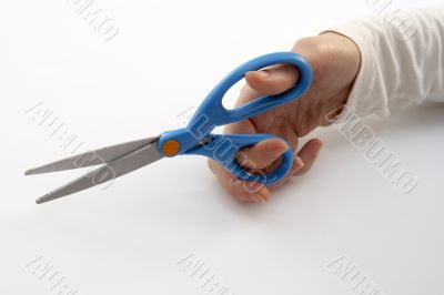 A hand holding scissors