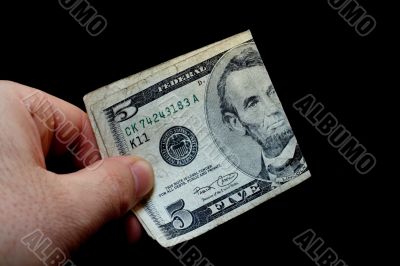 Man holding a five dollar bill