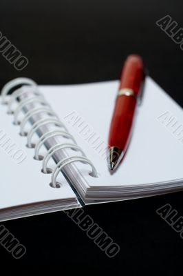 White notebook and pen