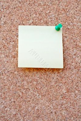 Yellow postit on a corkboard