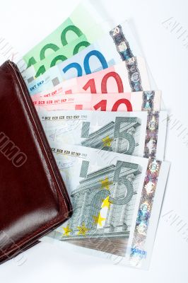 Old leather wallet with bills inside