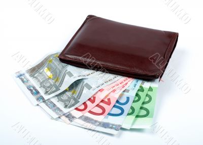 Old leather wallet with bills inside