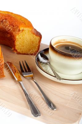 sponge cake with the cup of coffee and spoon