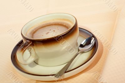 Close-up of a cup of coffee with the spoon