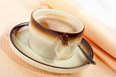 Close-up of a cup of coffee with the spoon