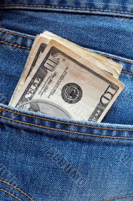 Ten dollars bills in a jeans pocket