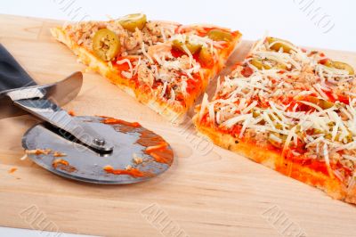 Detail of slices Italian pizza and cutter